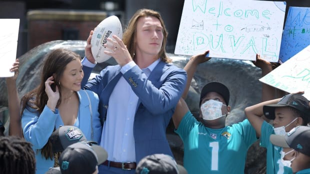 Trevor Lawrence and his wife Marissa Mowry pose with students from Long Branch Elementary School upon their arrival in Jacksonville Friday. The Jacksonville Jaguars' first-round draft pick Trevor Lawrence and his wife Marissa Mowry arrived at TIAA Bank Field in Jacksonville, Florida about noon Friday, April 30, 2021. The couple was greeted by team owner Shad Khan and 35 third-grade students from Long Branch Elementary School.